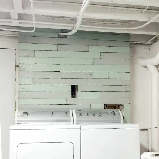 DIY budget-friendly pallet accent wall behind washing machine 