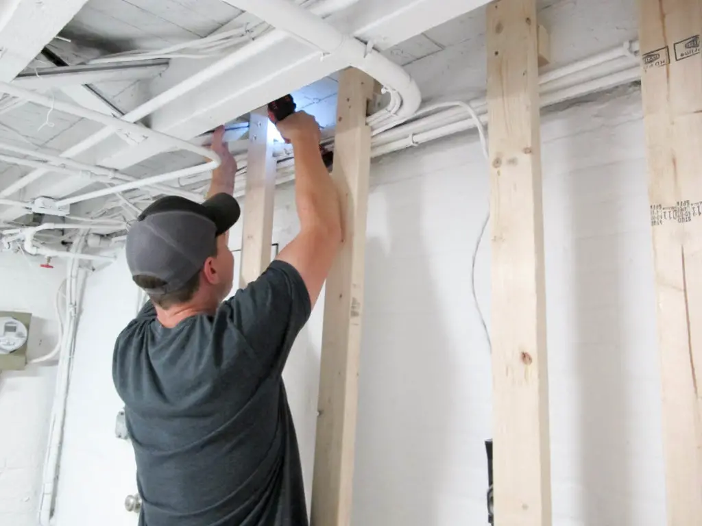 Adding a focal point in a basement laundry room - DIY pallet accent wall. 