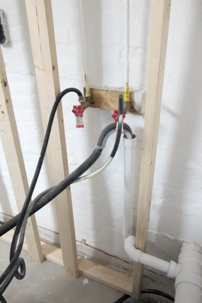 DIY accent wall to conceal visible pipes in a basement laundry room