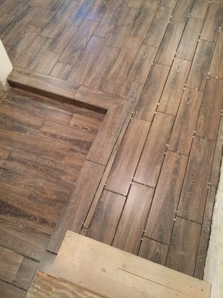 Faux wood ceramic tiles in a basement renovation. Great waterproof option that looks amazing. | EffieRow.com
#fauxwoodtiles #ceramicwoodtile #basementfloor #basementflooringoptions #basementtilefloor #basementwoodfloor