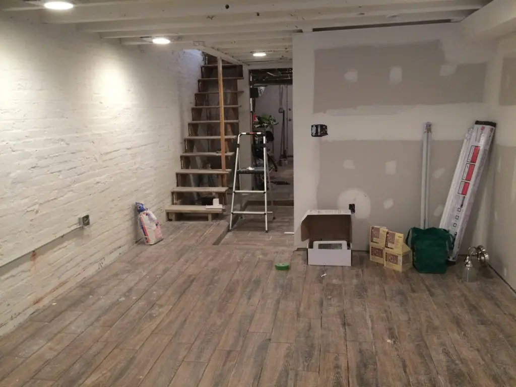 Faux wood ceramic tiles in a basement renovation. Great waterproof option that looks amazing. | EffieRow.com
#fauxwoodtiles #ceramicwoodtile #basementfloor #basementflooringoptions #basementtilefloor #basementwoodfloor