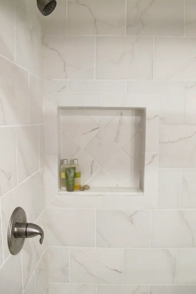 Recessed shower shelf between the studs. Simple addition for more shower storage. 