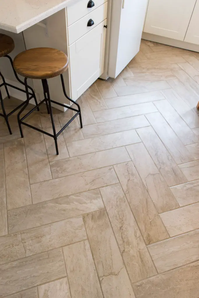 Herringbone tile floors and a breakfast bar in a small kitchen