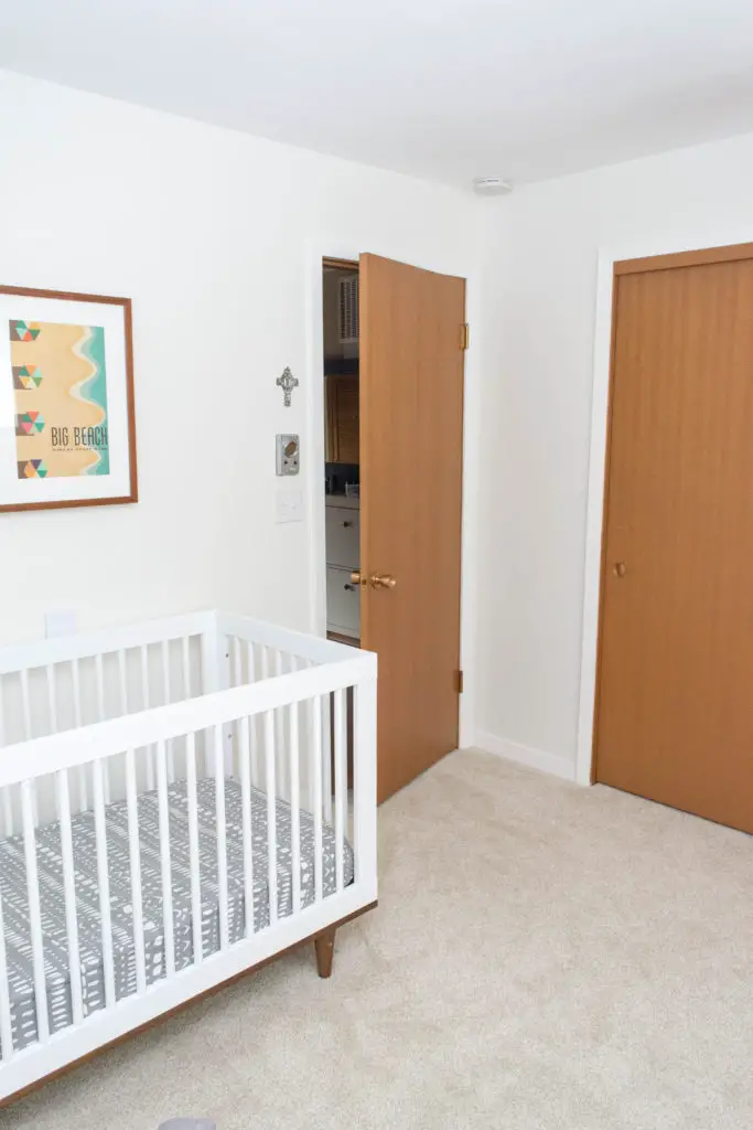 Gender neutral nursery in a mid century home. This is what leaving oak doors unpainted look like - adding new trim makes a big difference! Trim is BM Simply White and the walls are BM White Dove.