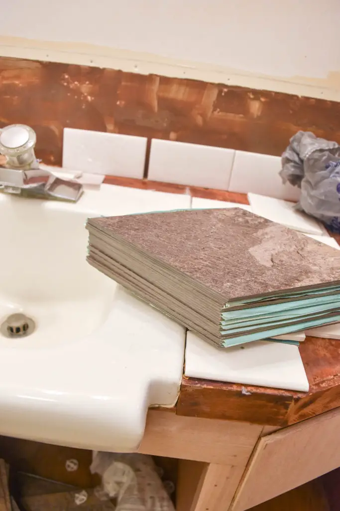 How to lay custom vinyl tile floors - great option for a bathroom renovation and easy way to cover up existing floors. Cut inexpensive vinyl tiles and lay them in any pattern you choose!